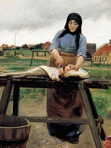 A woman from Skagen cutting a haddock.
