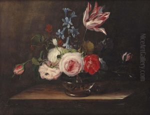 Roses, a tulip, and bluebells in a glass vase, on a wooden ledge