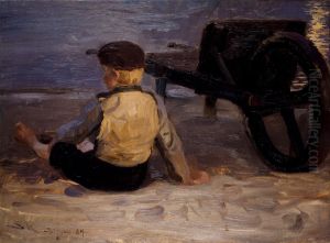 Fisher boy sitting beside a wheelbarrow. Skagen South Beach