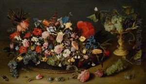 Elaborate basket of flowers and a tazza with grapes, on a table top