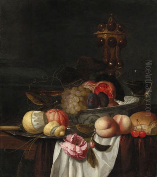 Grapes, pomegranates and plums in a Wanli bowl, an orange and peeled lemon on a pewter plate, peaches, cherries, bread, a rose, a roemer, a silver-gilt cup and tazza Oil Painting by Gillis van Hulsdonck