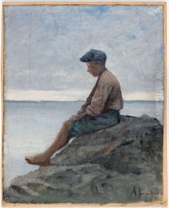 Rannalla istuva poika