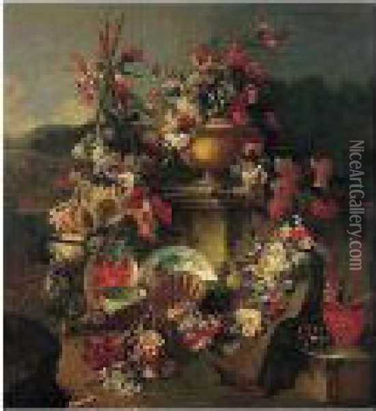 A Still Life Of Flowers In An 
Urn With Flower Garlands Draped On A Stone Pedestal And Surrounded By 
Flowers And Fruit, Including Sunflowers, Cherries, Figs And Watermelons,
 Together With Porcelain, Terracotta, Glass And Silver Plates And Bowls,
 In Oil Painting - Giuseppe Lavagna