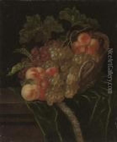 A Pomegranate, Apricots, Grapes 
And Peaches In A Wicker Basket On A Partly-draped Stone Ledge Oil Painting - Ernst Stuven