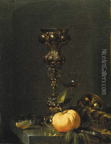 A Steeple Cup With Upturned Cover, A Glass Of Wine, An Orange And A Knife On An Oriental Rug On A Draped Marble Ledge Oil Painting - Willem Kalf