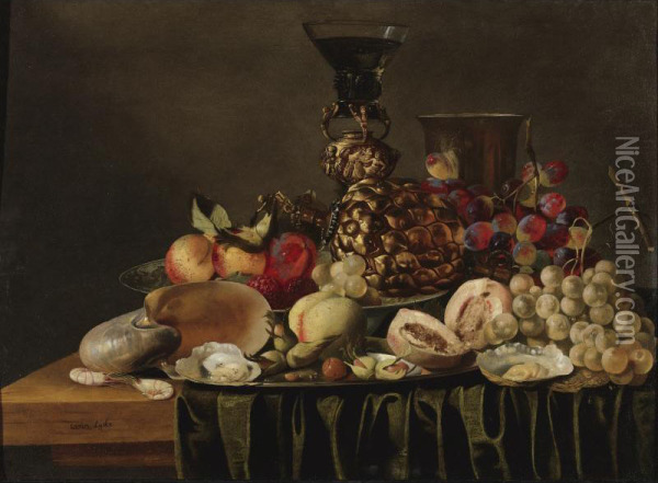 Still Life With A Gilt Cup And Glass Holder, A Silver Beaker, A Nautilus Shell, Fruit, And Oysters Arranged On A Draped Ledge. Oil Painting - Carstiaen Luyckx