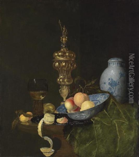 Still Life With A 
Roemer
, A Silver-gilt Columbine Cup, A Jar, A Porcelain Dish With An Orange And Peaches, A Bread Roll, And A Peeled Lemon, On A Table Oil Painting - Nicolaes Bourgeois