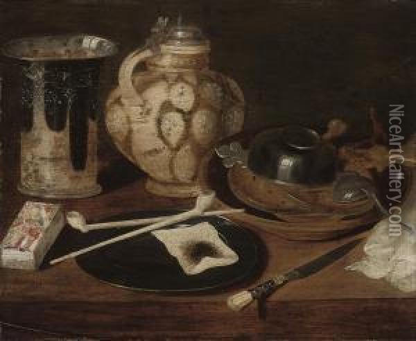 Pipes And Tobacco On A Pewter 
Plate, A Silver Mounted Rhinish Pitcher, A Deck Of Cards, And An Ecuelle
 And Various Other Vessels On A Wooden Table Oil Painting - Georg Flegel