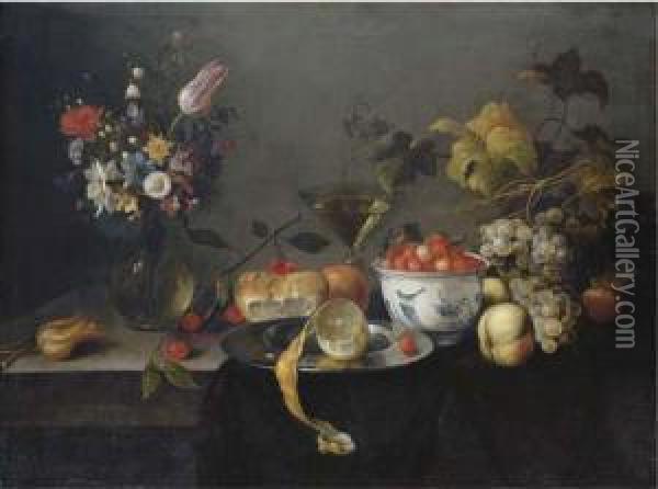 A Tulip, A Carnation, An Iris 
And Other Flowers In A Glass Vase, Wild Strawberries In A Wan-li 'kraak'
 Porselain Bowl, A Partly-peeled Lemon On A Pewter Platter With 
Cherries, An Orange, A Wine Glass, Apples And Grapes On A Draped Ledge Oil Painting - Michiel Simons