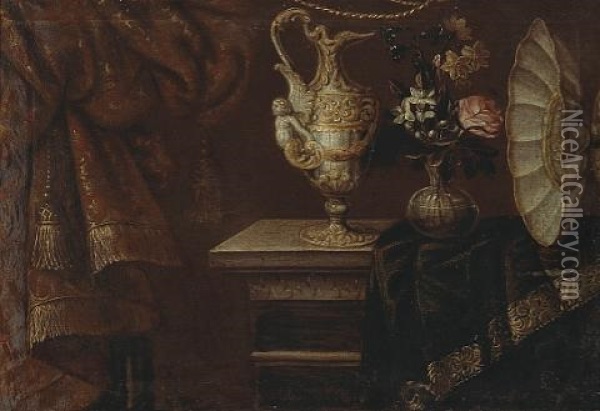 A Still Life With An Ewer, Footed Basin And Flowers In A Glass Vase On A Partially Draped Table Oil Painting - Antonio Gianlisi