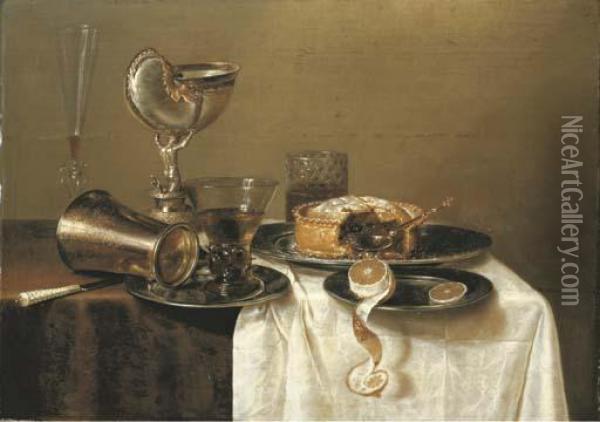 An Overturned Silver Tumbler And A Roemer On A Pewter Plate, A Facon-de-venise Wineglass, A Nautilus Cup, A Pie And A Partly-peeled Lemon On Pewter Plates On A Partly-draped Table Oil Painting - Gerrit Willemsz. Heda