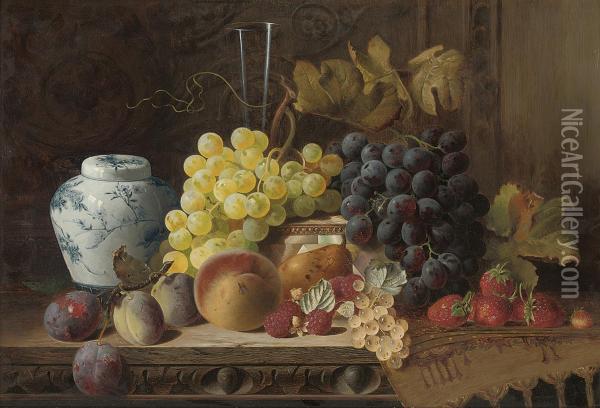 A Ginger Jar With Plums, A Peach, Pear, Raspberries, Whitecurrants, Black And White Grapes, Strawberries, A Glass Flute, Amother-of-pearl Box And A Rug On A Carved Wooden Table Oil Painting - Charles E. Baskett