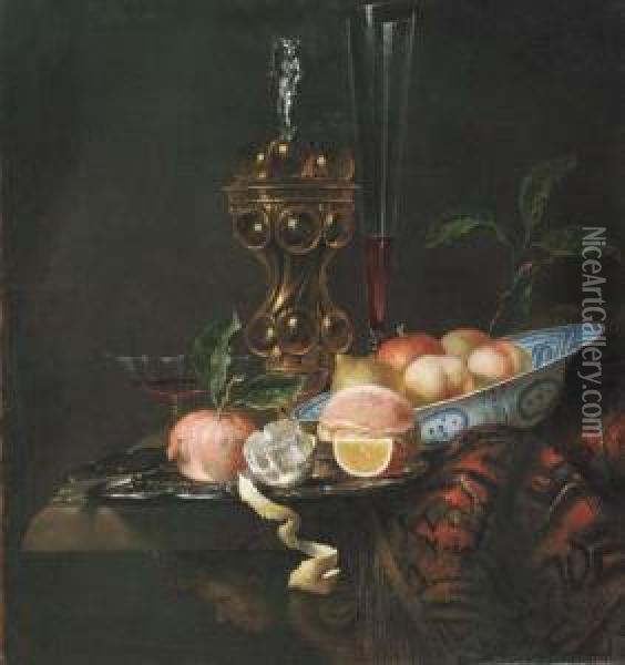 Peaches And A Lemon In A Wanli 
'kraak' Porselein Bowl, A Partlypeeled Lemon, An Orange Slice, A 
Pomegranate And Bread On A Pewterplate, A Gilt Cup And Cover And A Wine 
Flute On A Partly Drapedtable Oil Painting - Juriaen van Streeck