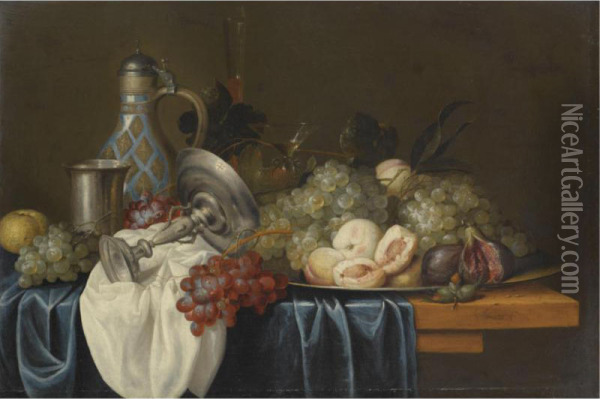 Still Life With Bunches Of Grapes, Peaches And Figs On A Pewter Dish, Together With A Silver Beaker And Tazza, A Wine Glass, A Flute And A Stoneware Jug, On A Table Draped With Blue And White Cloths Oil Painting - Alexander Coosemans