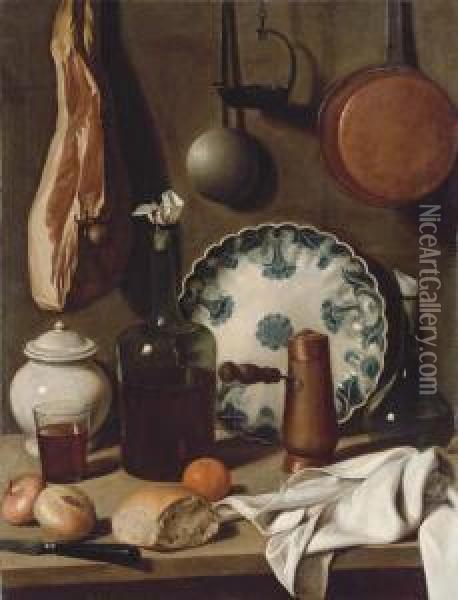 A Glass Bottle, A Blue And White
 Porcelain Platter, A Copper Coffeepot, A Flask, A Covered Jar, A 
Tumbler Of Wine, A Knife, Bread,onions And An Orange On A 
Partially-draped Table, With A Ham Andpans Suspended From The Wall Oil Painting - Carlo Magini