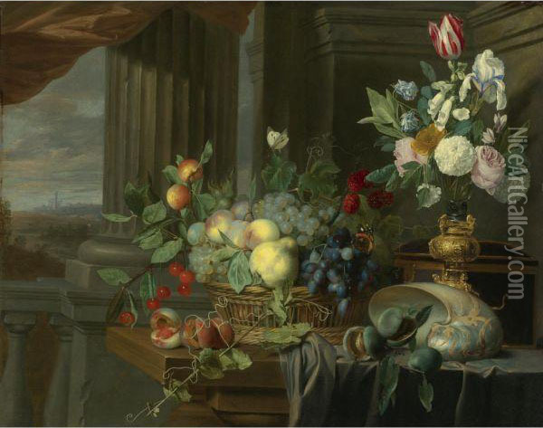 Still Life Of A Basket Of Fruit, Flowers In A Gilt Vase, A Nautilusshell And Other Objects On A Draped Table Near An Open Window, Alandscape Beyond Oil Painting - Carstiaen Luyckx