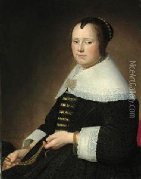 Potrait Of A Lady, 
Three-quarter-length, In A Black Dress With Gold Brocade, And A White 
Collar, Holding A Gold Chatelaine Oil Painting - Johannes Cornelisz. Verspronck