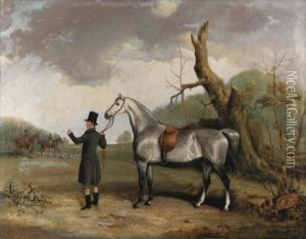 A Dappled Grey Held By A Huntsman, With Huntsmen And Hounds Beyond,in A Landscape Oil Painting - Thomas W. Bretland