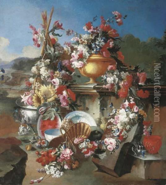 Roses, Narcissi, Carnations, 
Tulips And Other Flowers In An Urn With Flower Garlands Draped On A 
Stone Pedestal And Surrounded By Flowers And Fruit In A Landscape Oil Painting - Giuseppe Lavagna