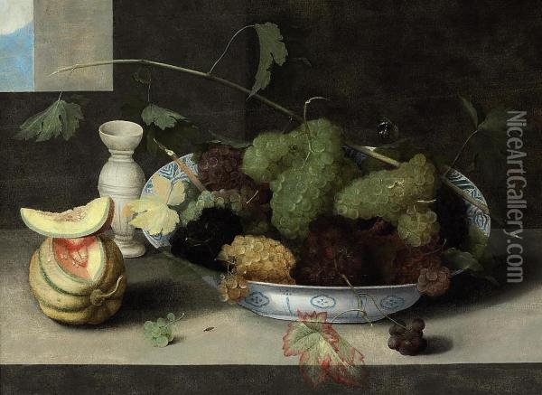 A Kraak Porcelain Bowl Of Grapes, With A Cut Melon And A Stonewarevase On A Stone Ledge Oil Painting - Peter Paul Binoit